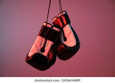 Boxing gloves are illuminated with red light - Powered by Shutterstock