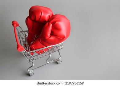 Boxing gloves inside shopping trolley with copy space. Fight inflation concept - Shutterstock ID 2197936159