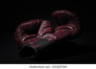 Boxing Gloves In A Low Light Room With Black Background