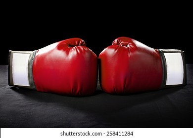 boxing gloves or martial arts gear on a black background - Shutterstock ID 258411284