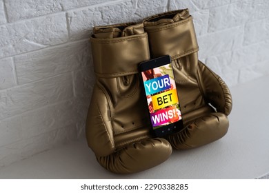 boxing gloves and smartphone with bets. - Shutterstock ID 2290338285