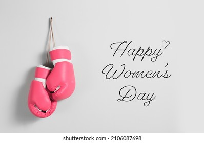 Boxing Gloves And Text HAPPY WOMEN'S DAY On Light Background