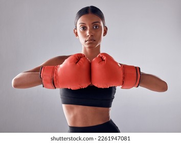 Boxing, hand gloves and portrait of woman in studio for sports exercise, strong muscle or mma training. Indian female boxer, workout and fight for impact, energy and warrior power in battle challenge - Powered by Shutterstock