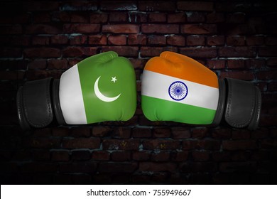 A Boxing Match. Confrontation Between The India And Pakistan. Indian And Pakistani National Flags On Boxing Gloves. Sports Competition Between The Two Countries. Concept Of The Foreign Policy Conflict