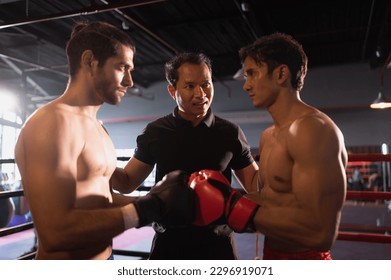 The boxing referee is explaining the rules before the two boxers fight., Muay Thai, Thai martial arts.