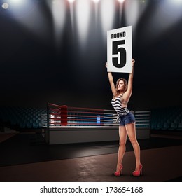 Boxing Ring Girl Holding A Board With Round Number. High Resolution 