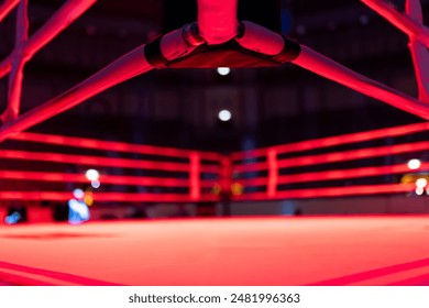 A boxing ring with red lights and a black and white logo - Powered by Shutterstock