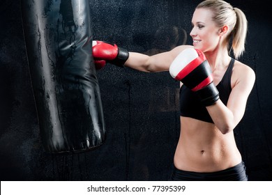 Boxing Training Woman With Punching Bag In Gym Wear Gloves