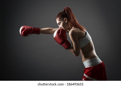 Boxing Woman During Exercise-gray Background