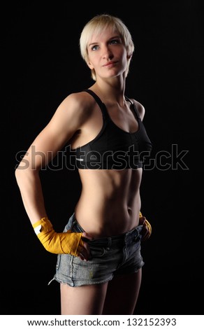 Similar – Close up front upper body portrait of one young athletic woman in sportswear in gym over dark background, looking at camera