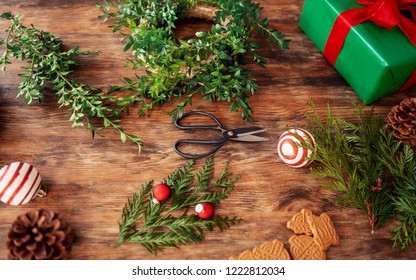 Boxwood Christmas Wreath. DIY Christmas Decoration Concept. Wooden Desk Top View.