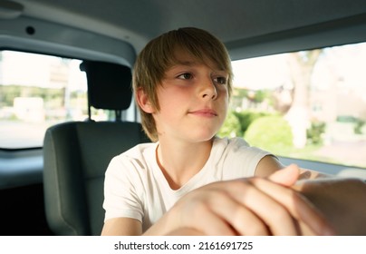 Boy 10 Years Old In A Car During Road Trip.