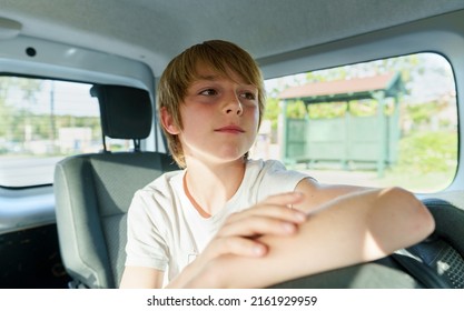 Boy 10 Years Old In A Car During Road Trip.