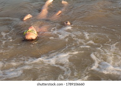 Boy 10 Years Old Enjoys Swimming In The Coastal Waves In The Sea