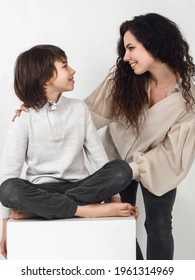 Boy 10 Years Old And Mother On A White Background In The Studio