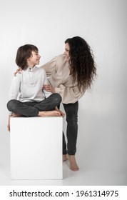 Boy 10 Years Old And Mother On A White Background In The Studio