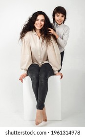 Boy 10 Years Old And Mother On A White Background In The Studio