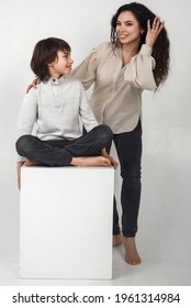 Boy 10 Years Old And Mother On A White Background In The Studio