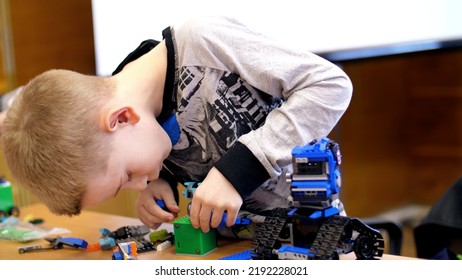 The Boy Of 10 Years, Plays In The Designer From Cubes, Plates, Circuits, Wires. A Small Inventor Creates Robots, Machines From Different Parts Of The Designer. Children Are Fond Of Robotics