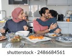 Boy (6-7) hugging father during family dinner