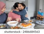 Boy (6-7) hugging father during family dinner