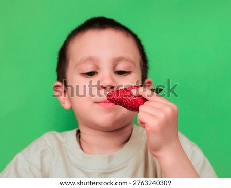 Boy About to Bite into Strawberry with Eyes Half Closed and Slight Smile — Child Savouring Fresh Summer Fruit, Mindful Eating, Sensory Pleasure and Healthy Food Concept