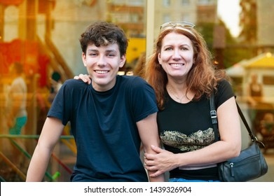 Boy of adolescence with his mother talk, laugh, have fun together all evening at sunset in the summer. Family summer time