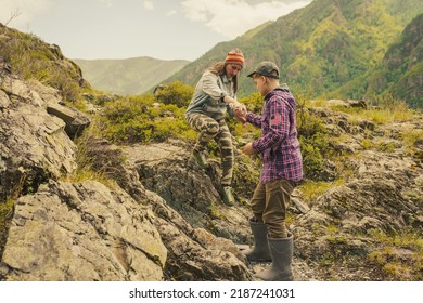 Boy And Adult Woman Hiking In The Mountains 