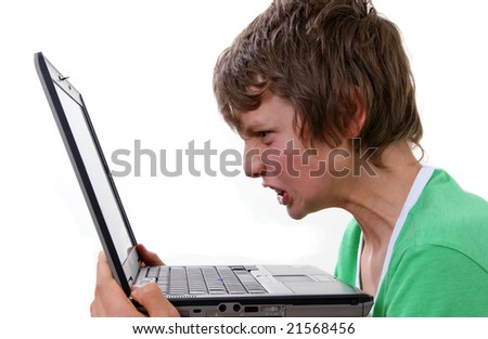 Boy with angy expression in front of computer
