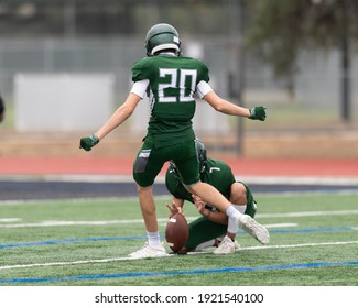 Boy athlete playing in a competitive football game