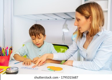 Boy with autism spectrum disorder learn literacy reading simple, teacher during ABA therapy class - Powered by Shutterstock