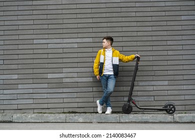 Boy with a backpack stands near his electric scooter - Powered by Shutterstock