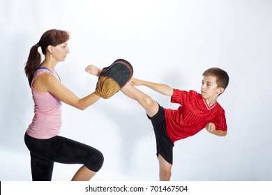 Boy Is Beating Kick Leg On The Simulator That Mom Keeps