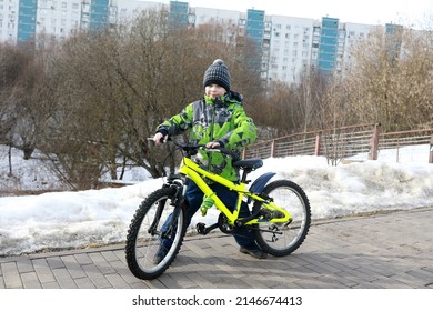 Boy With Bike On Sidewalk In Spring