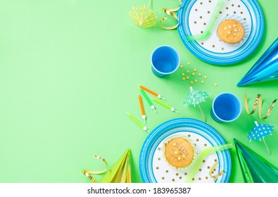 Boy Birthday Decorations. Green Table Setting From Above With Muffins, Drinks And Party Gadgets. Background Layout With Free Text Space.