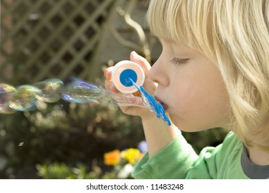 boy blowing soapbubbles