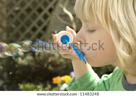 boy blowing soapbubbles