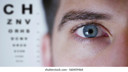 Boy With Blue Eyes On Background Ophthalmologist And Letters Metrics Miopismo And Eye Exam. Concept Of Keen Eyesight And Eye Examination. Perfect Vision