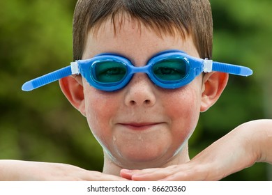 Boy In Blue Swim Goggles Having A Fun Time At The Pool