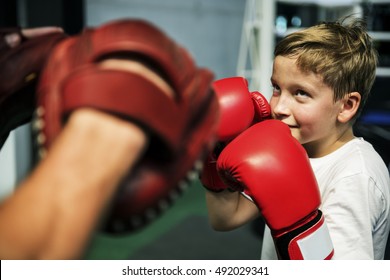 Boy Boxing Training Punch Mitts Exercise Concept - Powered by Shutterstock