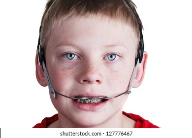 Boy with braces and headgear - Shutterstock ID 127776467