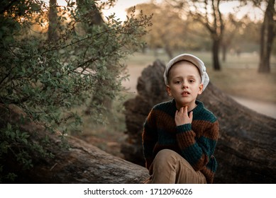 A Boy In A Brown Sweater Walks Throught The Spring Forest