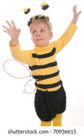 Boy In Bumble Bee Costume Smelling Red Flower