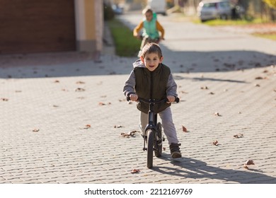 Boy At The Bycicle Walks At The Street