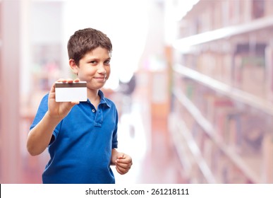 Boy With A Card In A Library