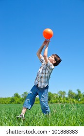 Boy Catching A Ball In The Outdoor