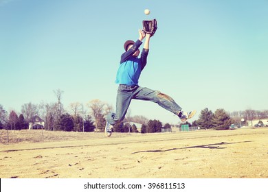 Boy Catching A Baseball, Sandlot Baseball, Focus On Shirt.