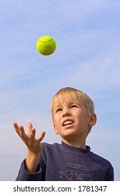 boy catching tennis ball