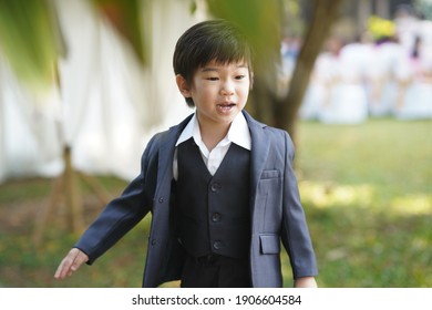 A Boy From Chiang Mai, Thailand In A Polite Suit To Attend A Wedding. With The Light Under The Tree That Looks Too Handsome