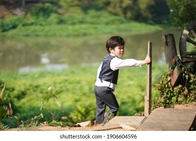 A Boy From Chiang Mai, Thailand In A Polite Suit To Attend A Wedding. With The Light Under The Tree That Looks Too Handsome